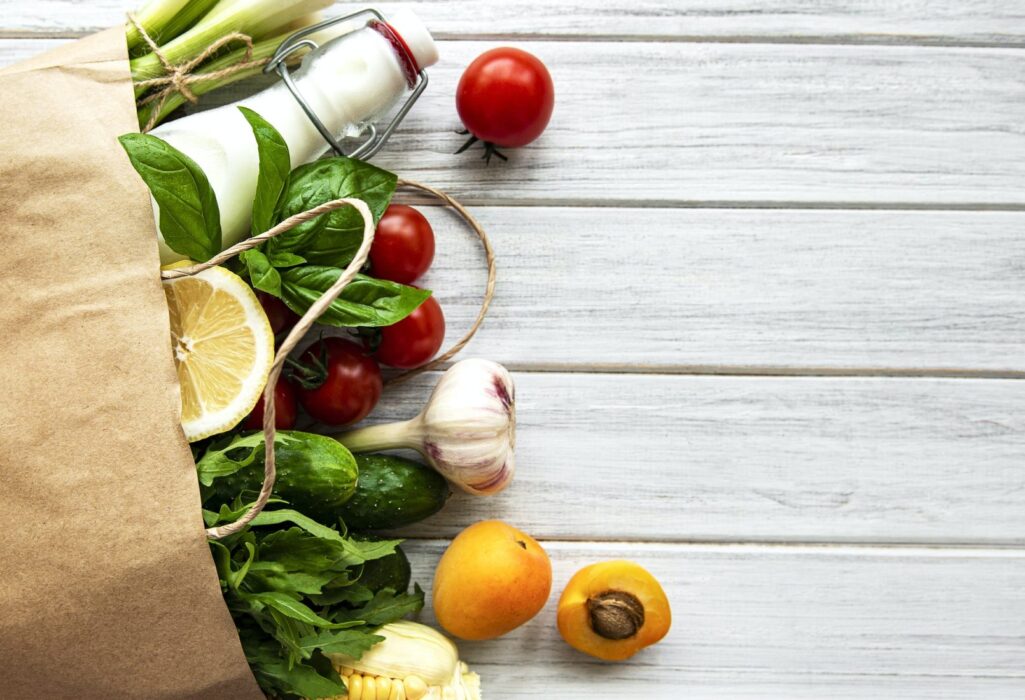 Healthy food background. Healthy food in paper bag, vegetables and fruits.